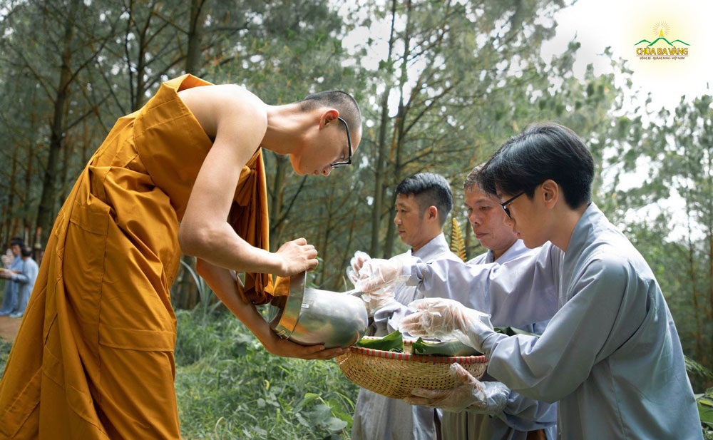 Phật tử trẻ thành kính sớt bát cúng dường chư Tăng